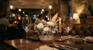 Modern table arrangement with two clear stemmed universal wine glasses and a floral centerpiece for date night.