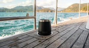 Unbreakable stainless steel insulated stemless wine glass sitting securely in a cup holder on a boat deck