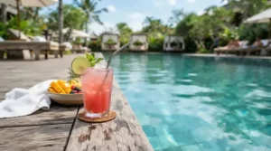 Unbreakable shatterproof glass wine glasses sitting safely by the edge of a sparkling backyard swimming pool.